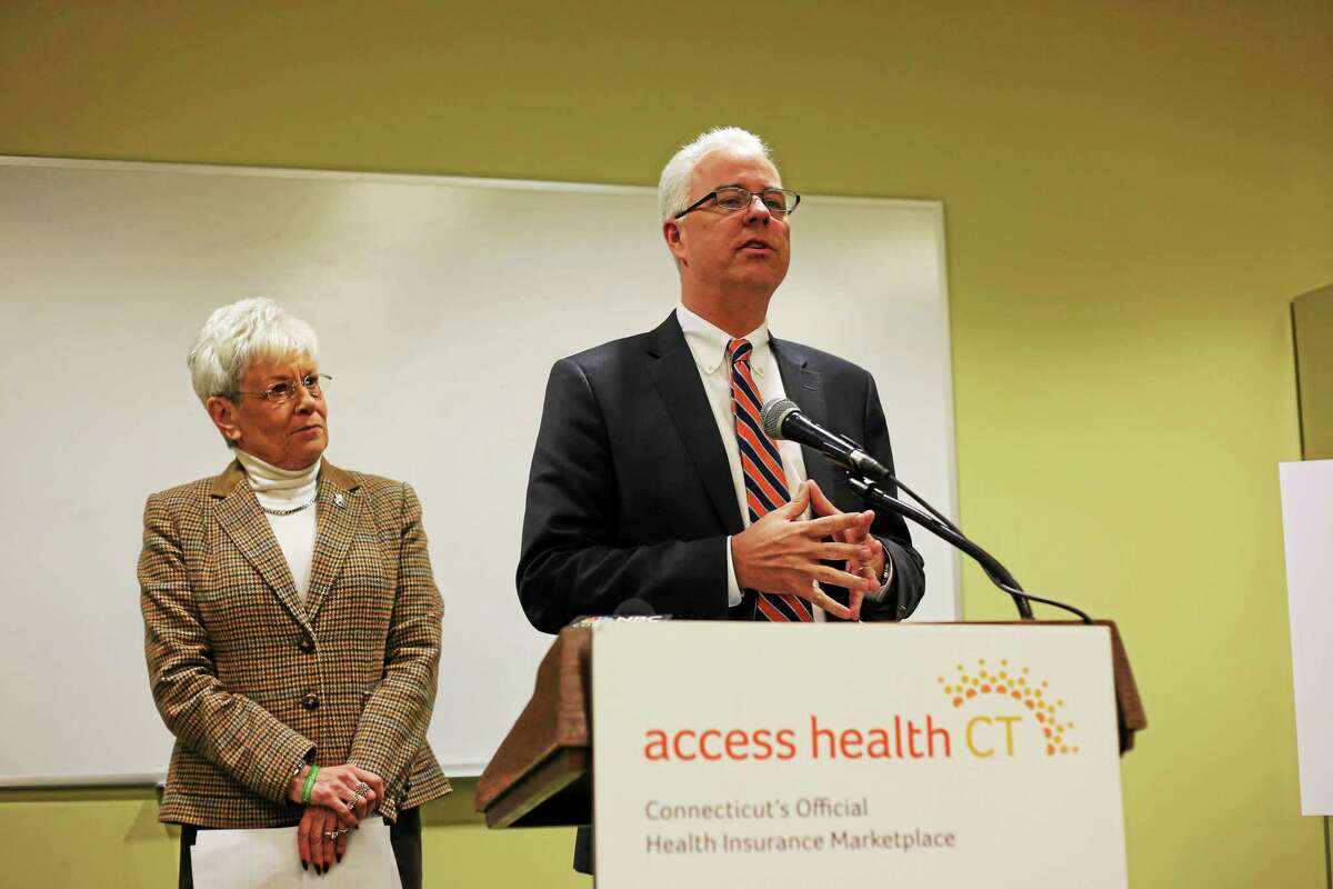 Access Health CT CEO Jim Wadleigh speaks at the podium while Lt. Gov. Nancy Wyman looks on.