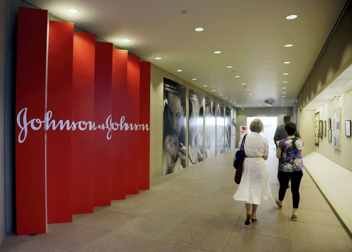 People walk along a corridor at the headquarters of Johnson & Johnson in New Brunswick, N.J.