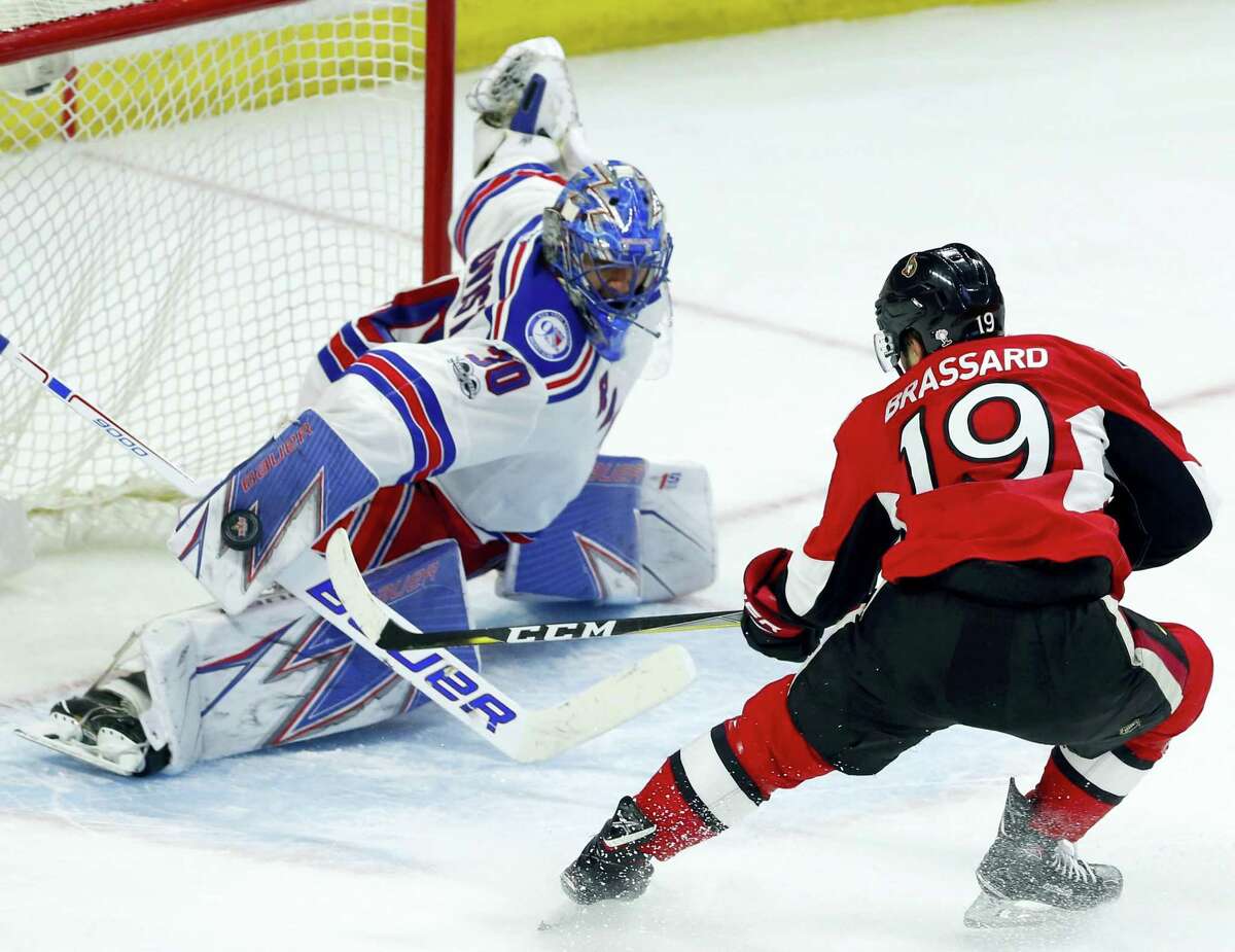 New York Rangers goaltender Henrik Lundqvist (30) makes a save as Ottawa Senators’ Derick Brassard (19) looks on during the third period of an NHL hockey game in Ottawa on April 8, 2017.