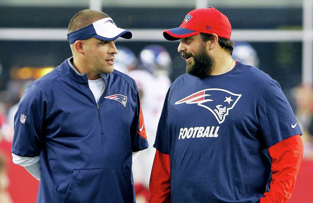 New England Patriots offensive coordinator Josh McDaniels, left, talks with defensive coordinator Matt Patricia.
