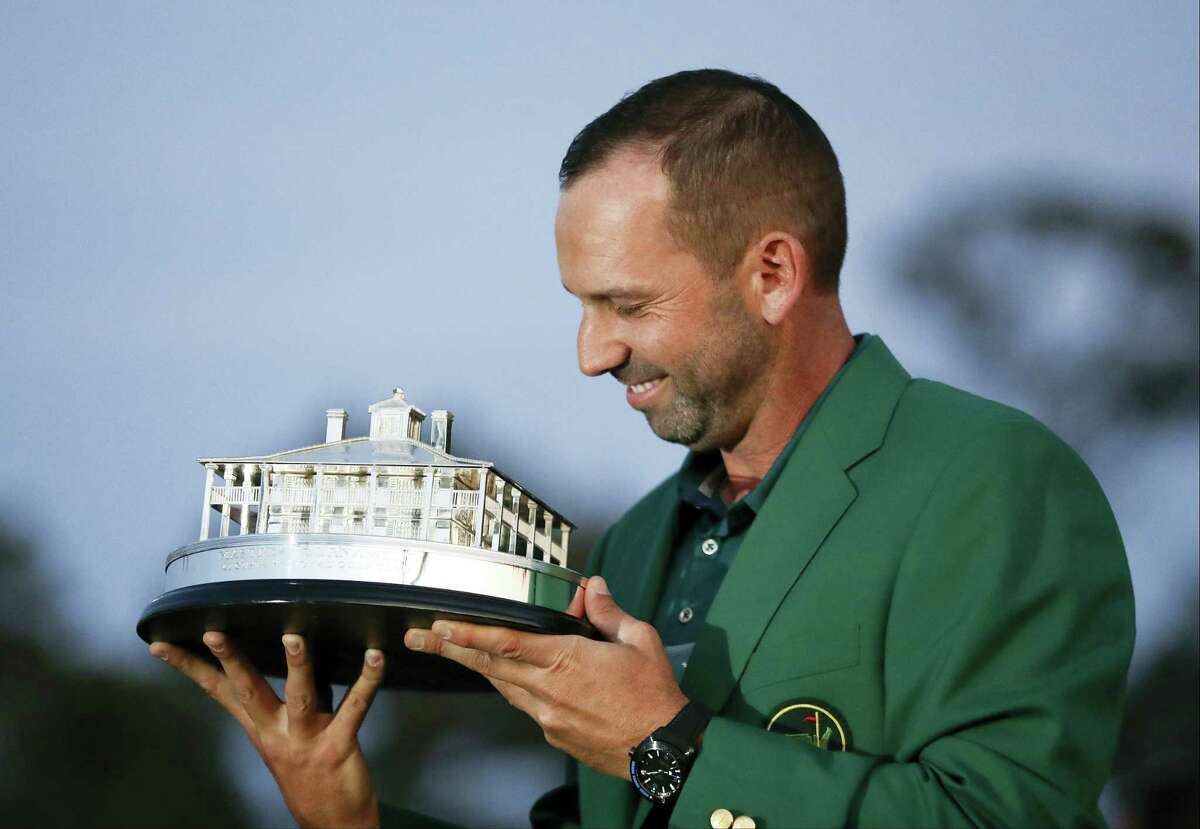 Sergio Garcia, of Spain, kisses his trophy at the green jacket ceremony after the Masters golf tournament Sunday in Augusta, Ga.