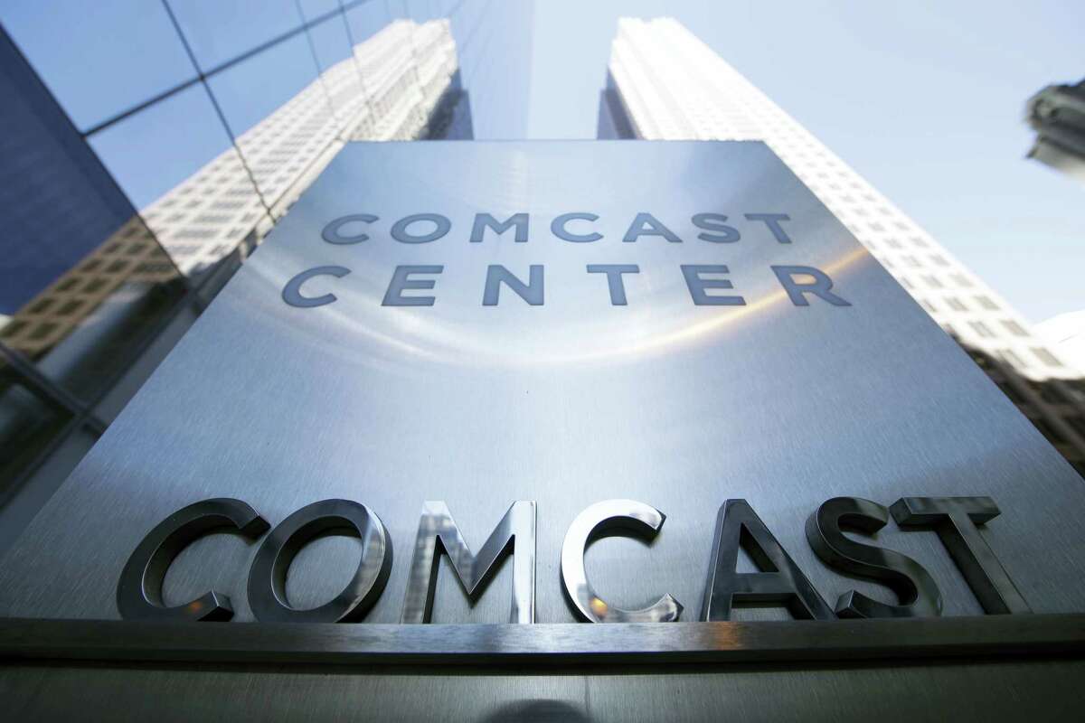 This March 29, 2017 photo shows a sign outside the Comcast Center in Philadelphia. Cable operators Comcast and Charter Communications have agreed to form a wireless partnership in order to strengthen their positions in the rapidly growing sector. Comcast and Charter Communications Inc. said Monday, May 8, that their partnership will give customers more choice and competitive prices.