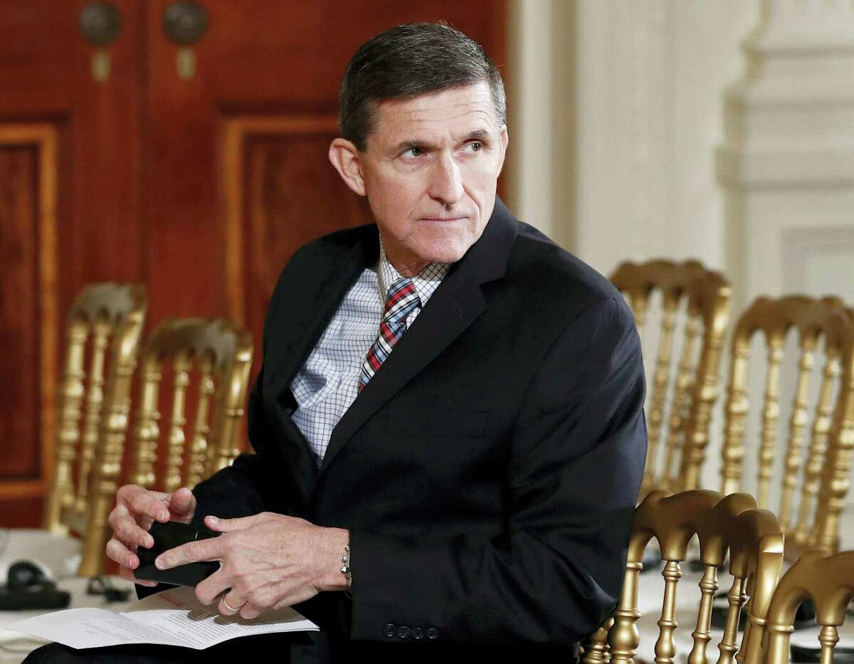 In this Feb. 10, 2017 photo, then-National Security Adviser Michael Flynn sits in the East Room of the White House in Washington. President Barack Obama warned Donald Trump against hiring Michael Flynn as national security adviser during an Oval Office meeting in the days after the 2016 election, according to three former Obama administration officials.