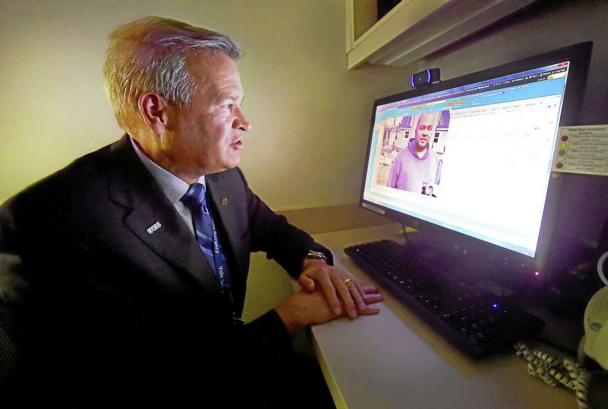 Dr. David Mulligan, Chief, Yale New Haven Hospital organ transplantation, speaks with his kidney transplant patient Michael Merzon, 39, of Naugatuck, using a virtual video visit Wednesday, January 4, 2017. Yale New Haven Hospital is the first hospital in Connecticut to effectively use virtual video visits with patients to enhance the patient experience and help patient s more efficiently manage their personal care. The YNHH department of organ transplantation became the first to use this technology in October 2016.
