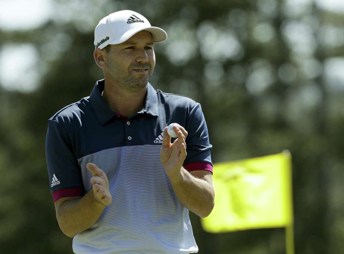 Sergio Garcia claps after putting on the 18th green.