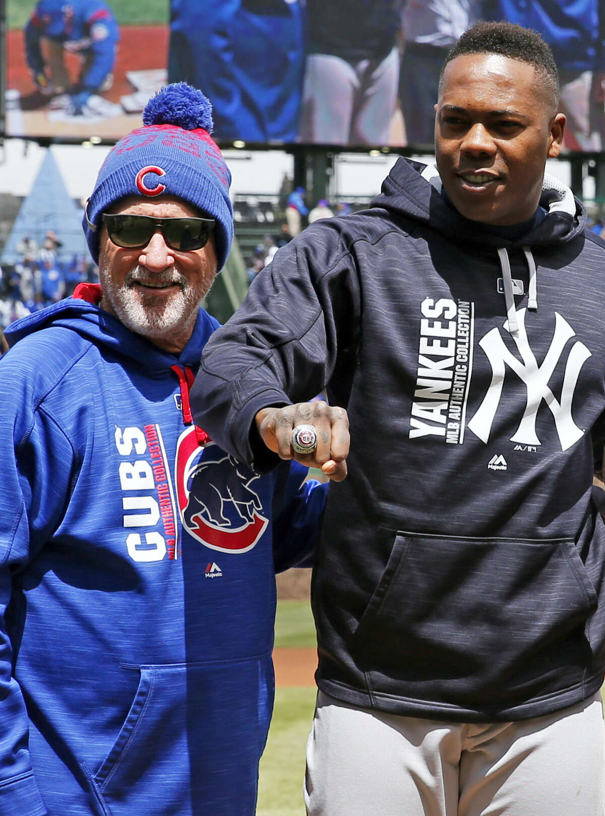 New York Yankees Aroldis Chapman (R) smiles after receiving from Chicago  Cubs manager Joe Maddon (L) his 2016 World Series Championship Ring before  the game against the Chicago Cubs at Wrigley Field