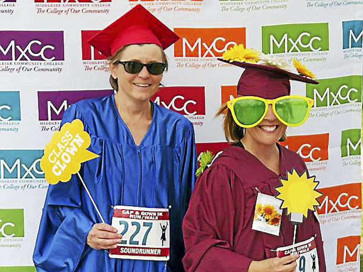 This year’s Middlesex Community College Cap & Gown 5K will coincide with the school’s 50th anniversary celebration. Here, Kathleen Molski and Christie Billings, both runners who work at Middletown’s Russell Library, donned caps and gowns for the 2016 race.