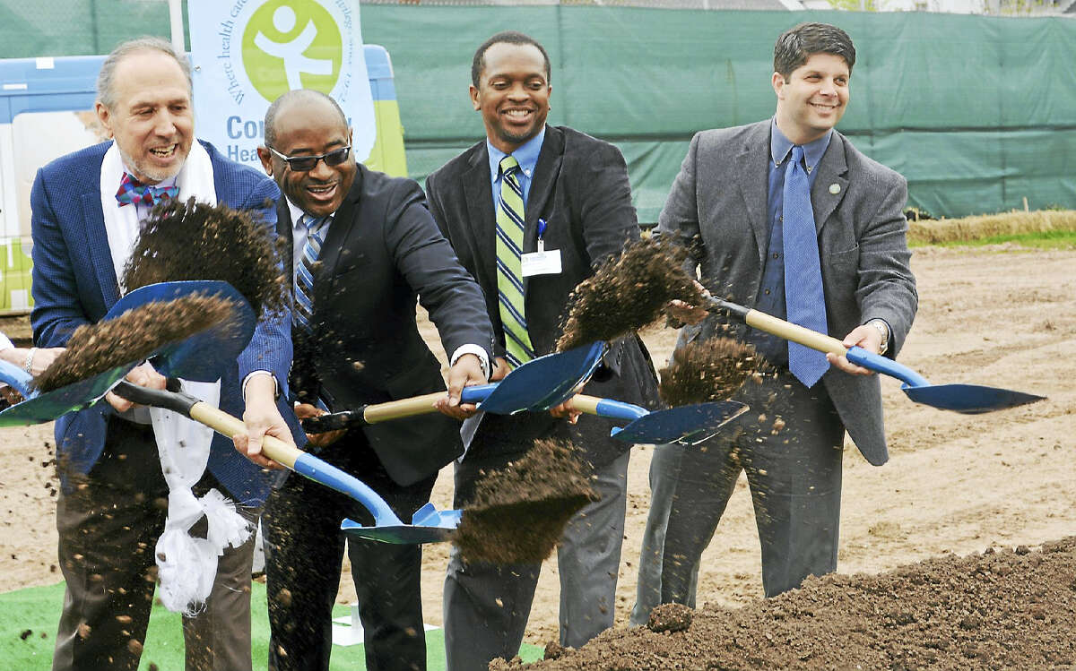 Community Health Center launched construction of its Knowledge and Technology Center in Middletown Monday on the 45th anniversary of the organization’s founding. Here, CEO and founder of CHC Mark Masselli, the Rev. Moses Harville, Board of Directors Chairman Gary Reid and Middletown Mayor Dan Drew dig in to the earth on the Grand Street lot.