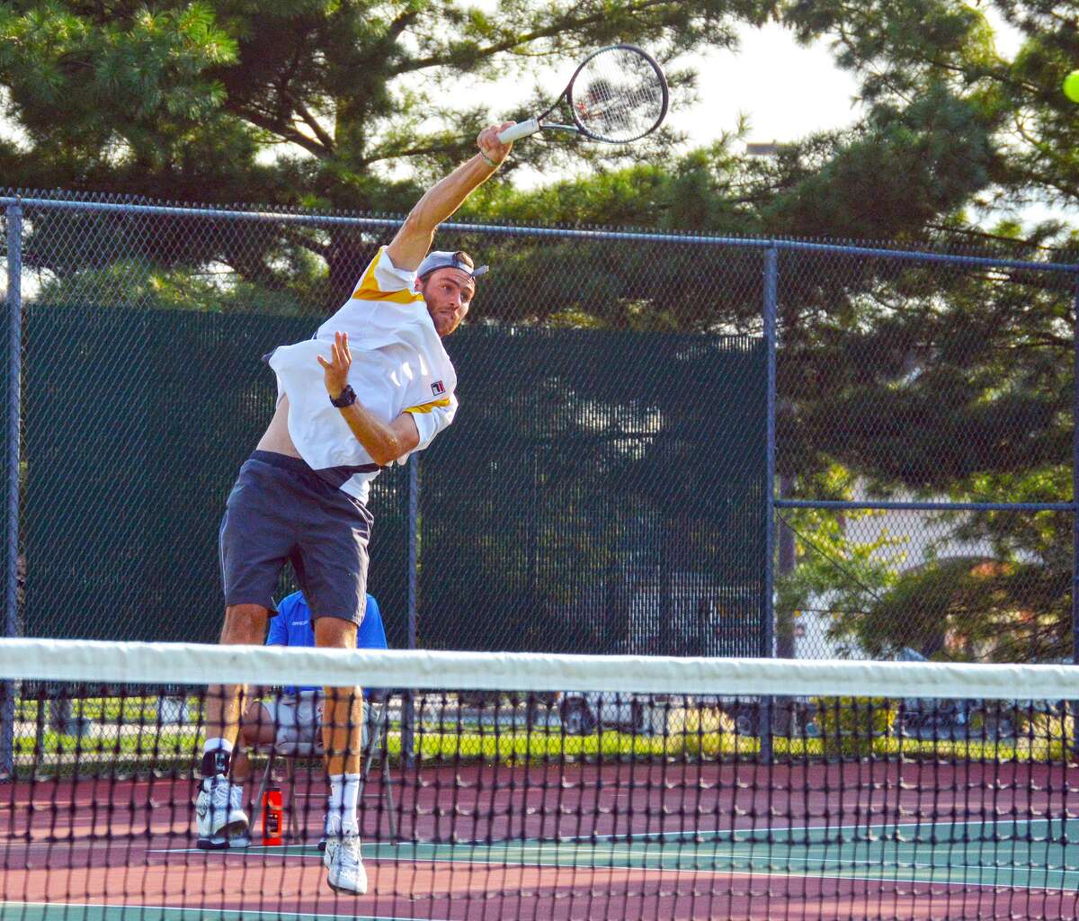 Hunter Callahan makes an overhead return during Friday's doubles final at the USTA Edwardsville Futures.