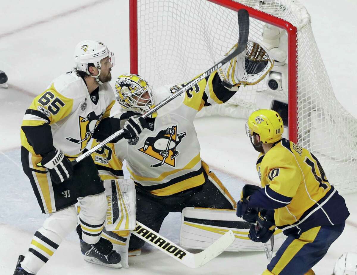 Penguins goalie Matt Murray and defenseman Ron Hainsey stop a shot by the Predators’ Colton Sissons during Game 4 of the Stanley Cup Finals on Monday in Nashville.
