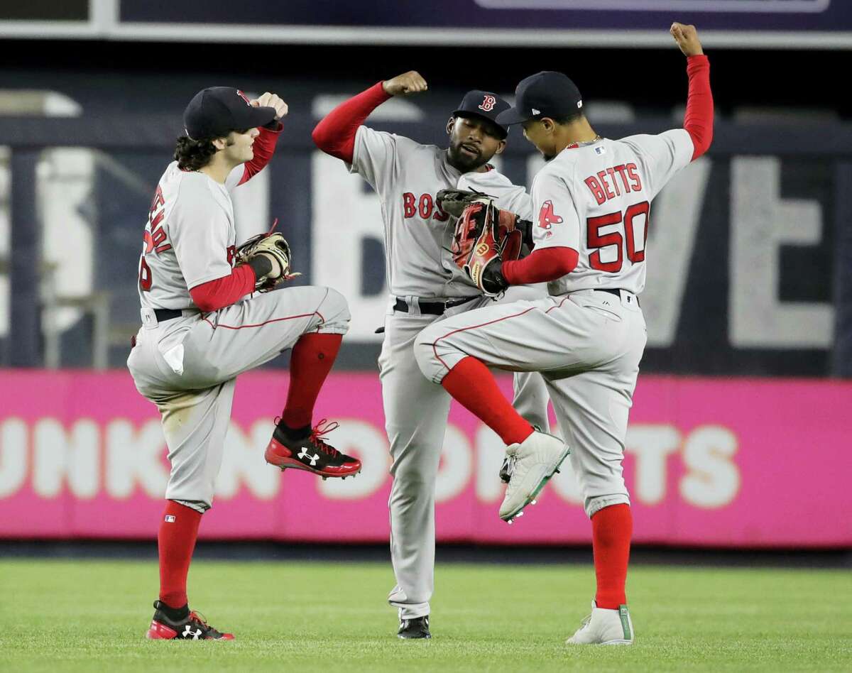 Red Sox outfielder Andrew Benintendi, left, celebrates with teammates Mookie Betts, right, and Jackie Bradley Jr. after Tuesday’s win over the Yankees.