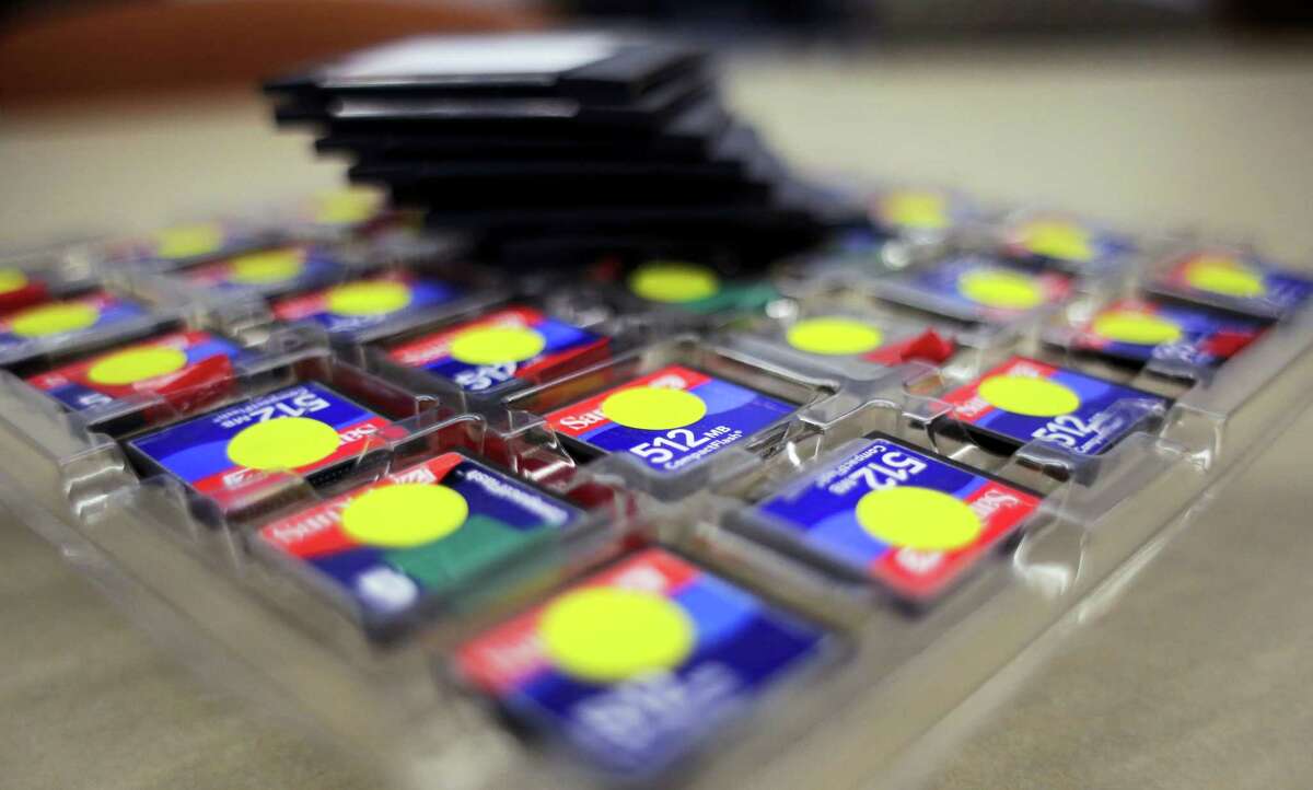 In this Thursday, March 9, 2017 photo, a stack of zip disks and a tray of compact flash cards sit at the Bexar County Elections office, in San Antonio. Bexar County’s voting equipment is among the oldest in America’s second-largest state and will have to be replaced soon. But money to do so is scarce and that scenario is playing out around the country. (AP Photo/Eric Gay)