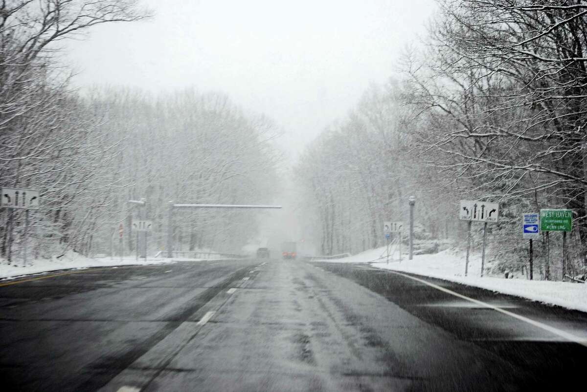 Snow is falling Friday morning on Route 34 in West Haven.
