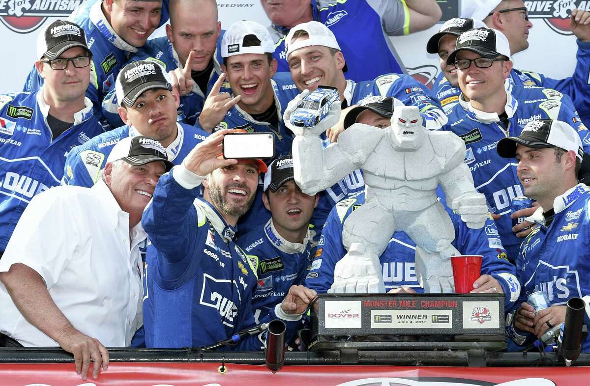 Jimmie Johnson, second from front left, at Victory Lane after winning at Dover International Speedway in Dover, Del. Sunday.