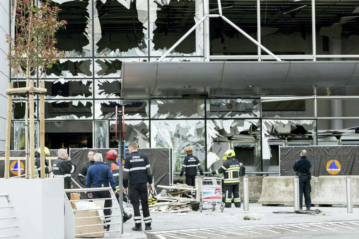 In this March 23, 2016 photo, police and other emergency workers stand in front of the damaged Zaventem Airport terminal in Brussels. The deadly vehicle and knife attack June 3, 2017 on London Bridge and in nearby Borough Market is the latest attack in Europe in recent years. On March 22, 2016, suicide attacks on the Brussels airport and subway kill 32 and injure hundreds. The perpetrators have been closely linked to the group that carried out earlier attacks in Paris.