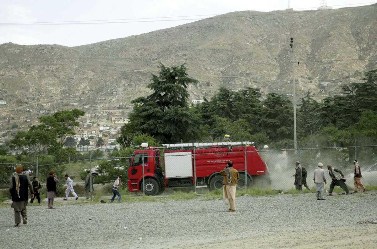 Angry men stone a fire fighter vehicle at the site of three suicide attacks during a funeral ceremony, in Kabul, Afghanistan, Saturday, Jun 3, 2017. Explosions in Kabul on Saturday killed at least six people attending a funeral reportedly attended by government officials, including members of parliament, a day after hundreds of demonstrators turned out to demand more security in the capital.