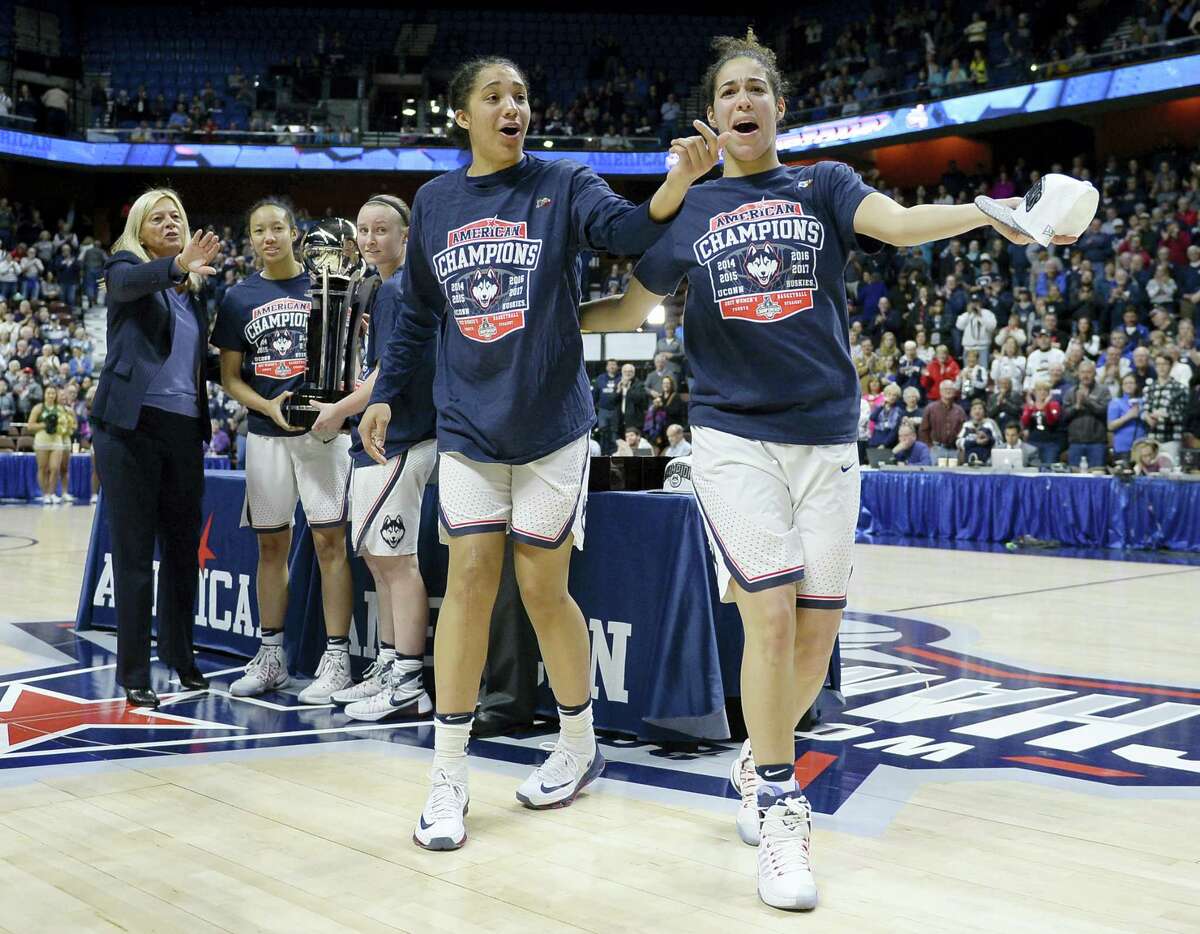 UConn’s Gabby Williams and Kia Nurse playfully react during Monday’s AAC championship trophy ceremony.