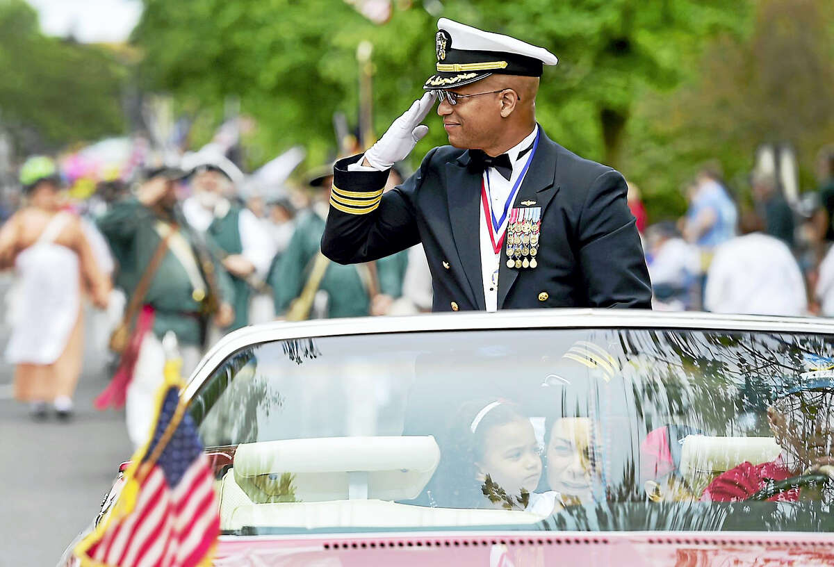 Grand Marshal Michael Thomas, a U.S. Navy commander, salutes during the Milford Memorial Day Parade.