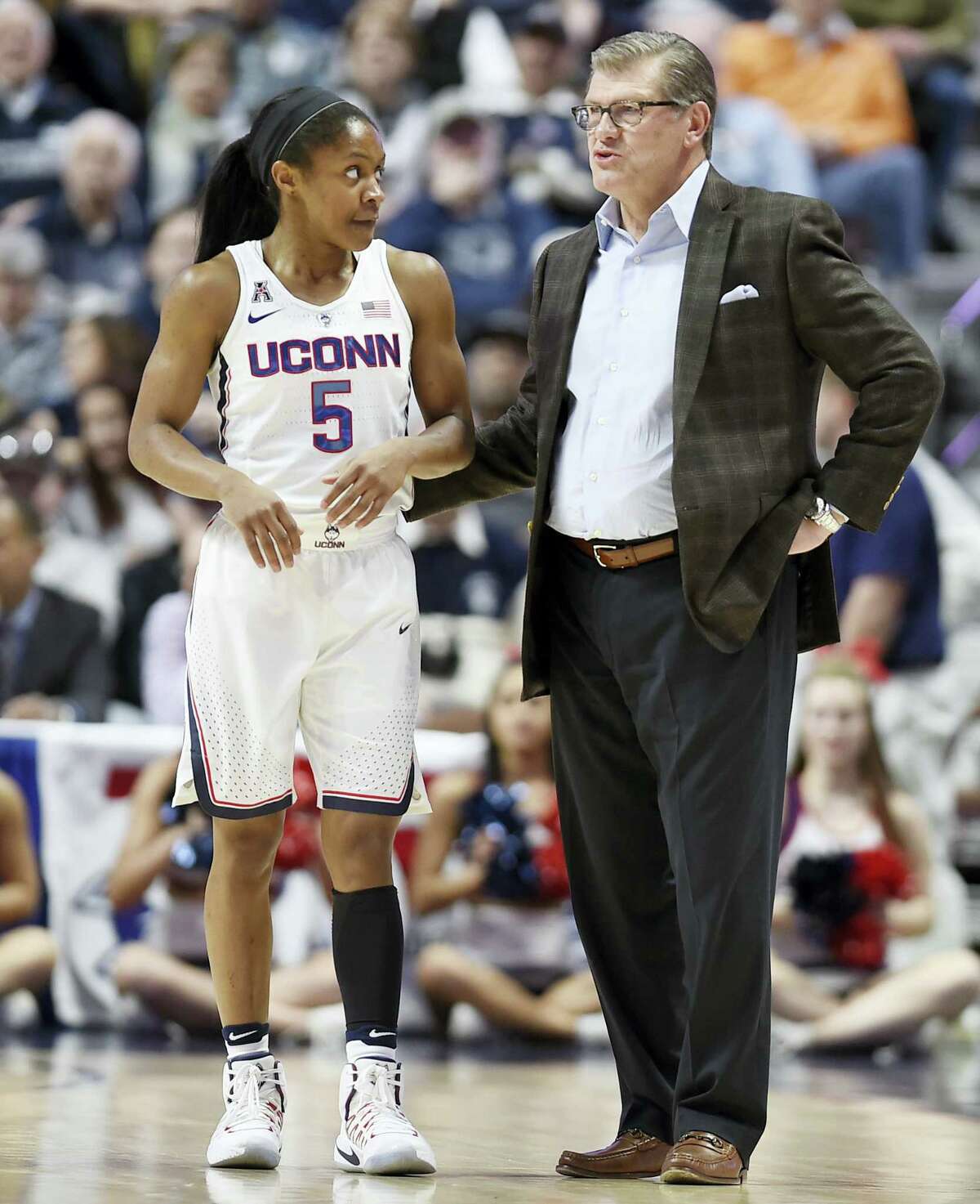 UConn head coach Geno Auriemma, right, talks with Crystal Dangerfield during Sunday’s AAC semifinal.