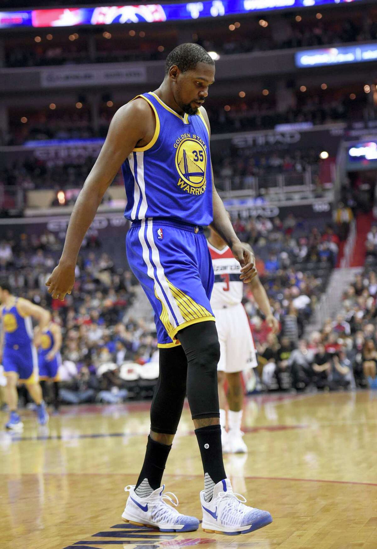 Golden State Warriors forward Kevin Durant (35) walks to the bench during the first half of an NBA basketball game against the Washington Wizards on Feb. 28, 2017 in Washington. Durant hyperextended his left knee and exited the Golden State Warriors’ game at the Washington Wizards for good after all of 93 seconds Tuesday night.