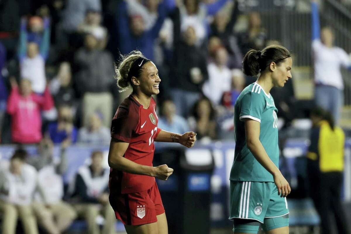 United States’ Lynn Williams, left, celebrates near Germany’s Dzsenifer Marozsan after Williams scored during the second half Wednesday in Chester, Pa.