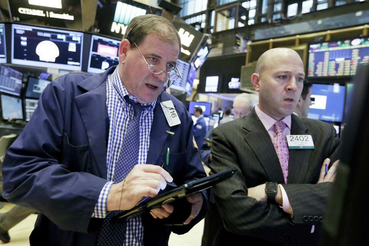 Jonathan Niles, left, and Jay Woods work on the floor of the New York Stock Exchange Wednesday.
