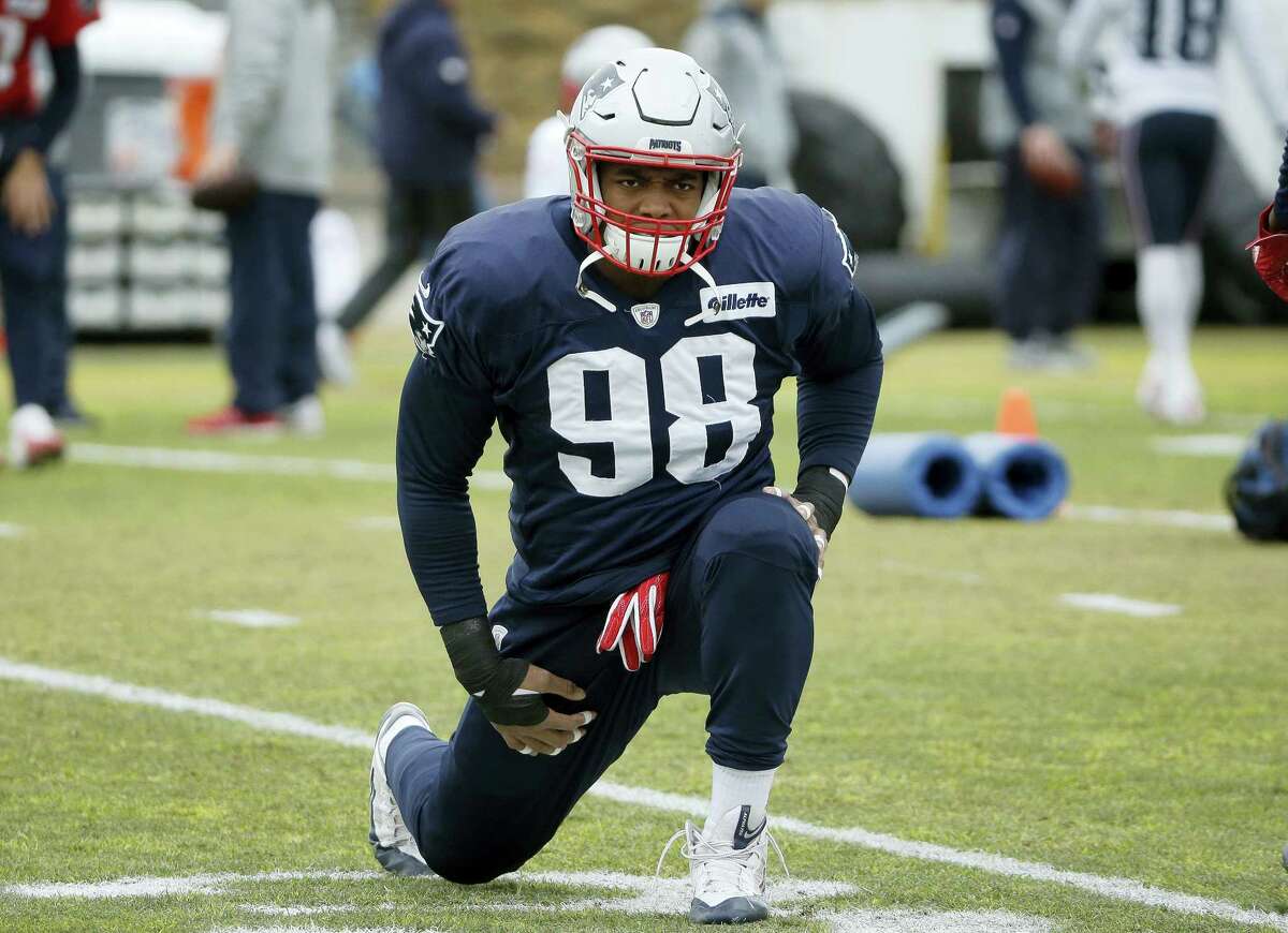 New England Patriots defensive end Trey Flowers stretches during an NFL football practice on Jan. 4, 2017 in Foxborough, Mass.