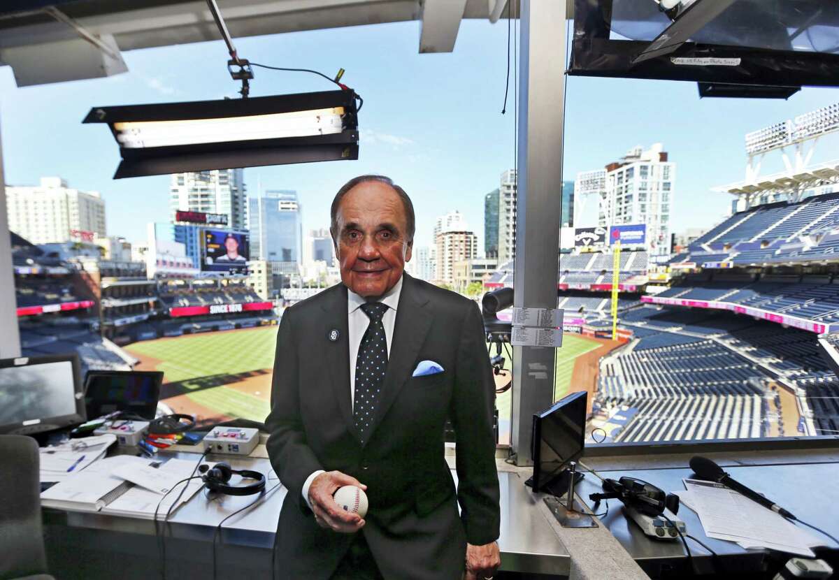 Dick Enberg, the voice of the San Diego Padres, poses in his booth prior to the Padres’ final home baseball game in San Diego.