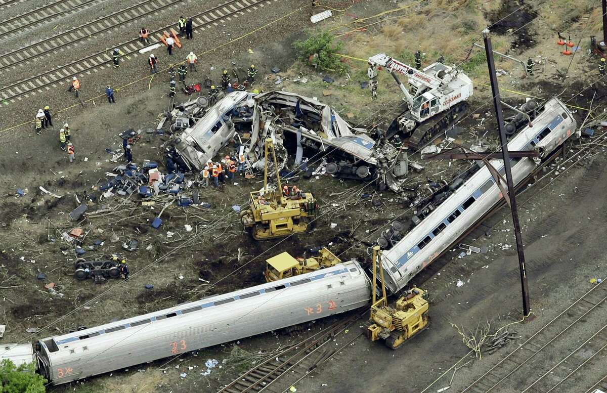 In this May 13, 2015 photo, emergency personnel work at the scene of a Tuesday night derailment in Philadelphia of an Amtrak train headed to New York. Federal investigators are expected to release interview transcripts, locomotive data and other evidence Monday, Feb. 1, 2016 that could help clear up the mystery of why the train streaked into a sharp curve at double the speed limit.