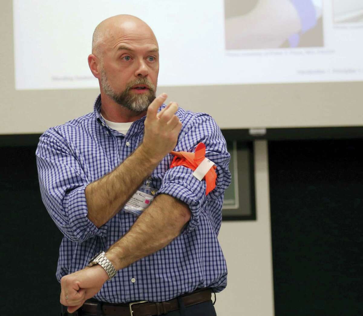 Colby Rowe, a paramedic educational coordinator for Stony Brook University Hospital’s Trauma Center, demonstrates how to apply a tourniquet during a training session for Stony Brook University administrators and security staff, Tuesda in Stony Brook, N.Y. Stony Brook University personnel were given instruction on how to treat gunshot wounds, gashes and other injuries until actual EMTs can get to the scene.