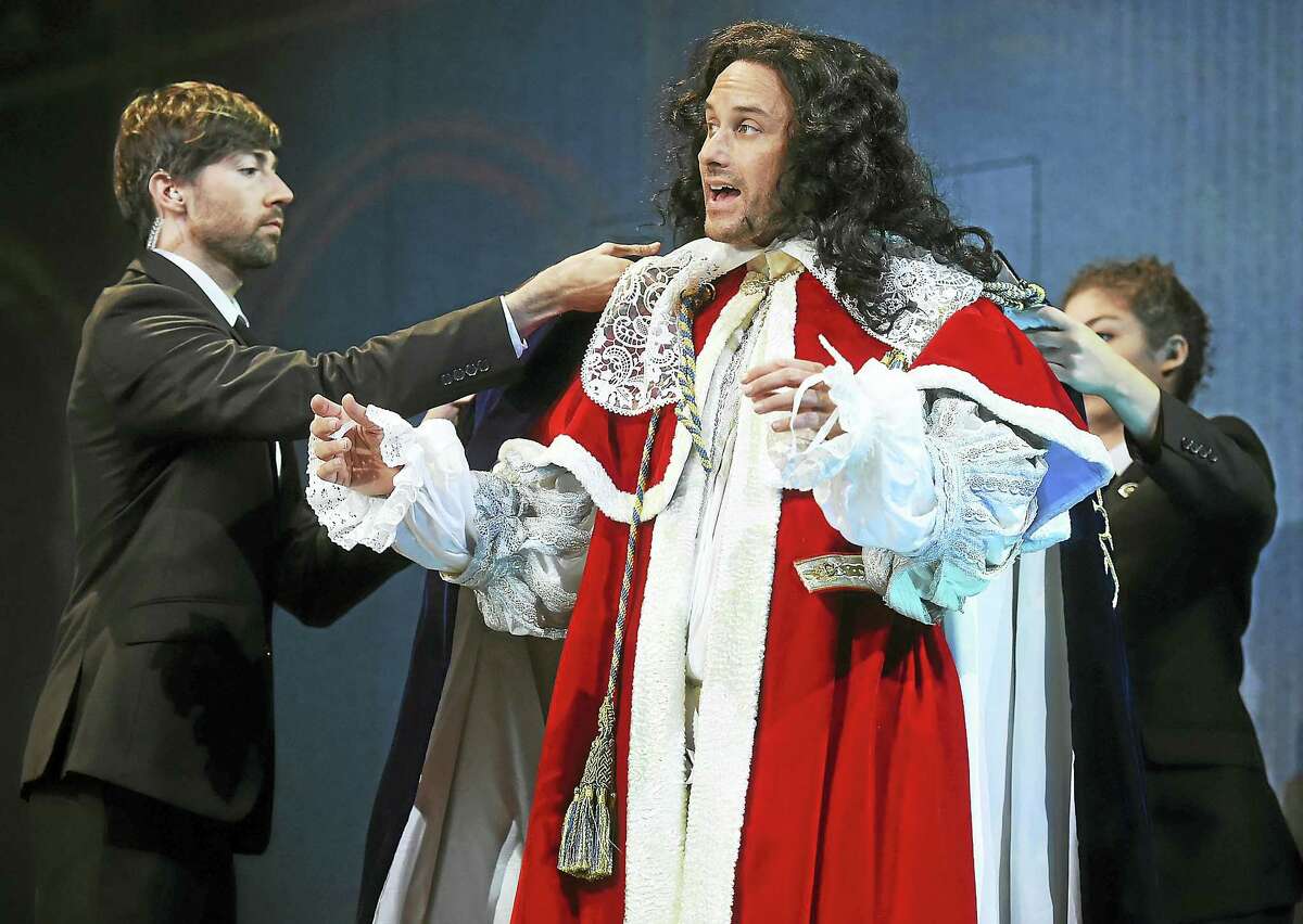 Greg Keller as Charles II and George W. Bush and members of the ensemble, Hudson Oznowicz and Evelyn Giovine, in dress rehearsal at the Yale Repertory Theatre world premiere of “Scenes from Court Life, or the whipping boy and his prince,” on Wednesday at University Theatre at 222 York St. in New Haven. The production runs through Oct. 22.