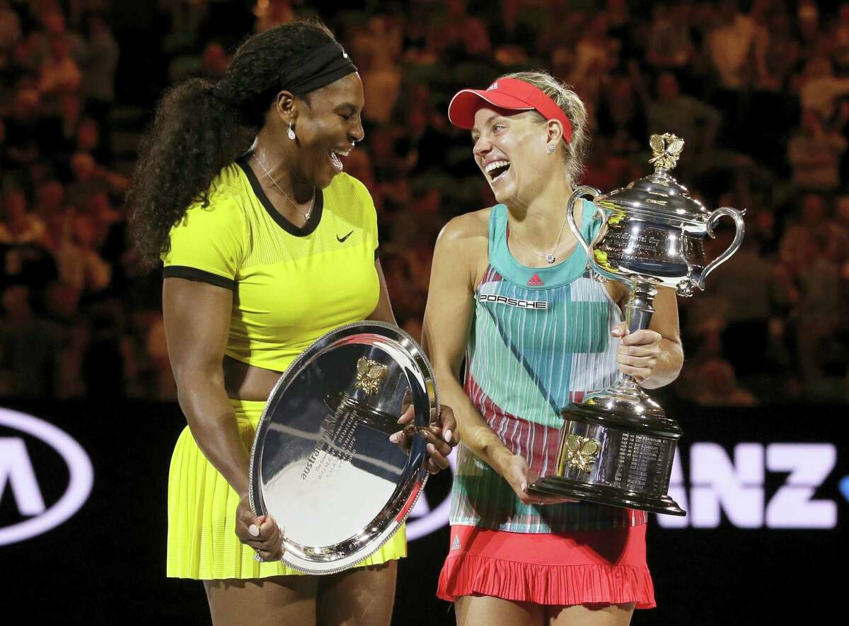 Angelique Kerber, right, of Germany enjoys a joke with runner-up Serena Williams of the United States after winning their women’s singles final at the Australian Open tennis championships in Melbourne, Australia, Saturday, Jan. 30, 2016.