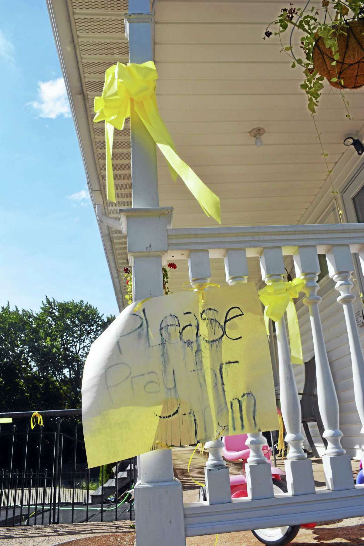 Yellow ribbons are tied along bannisters and railings at Linda Carman’s Middletown home.