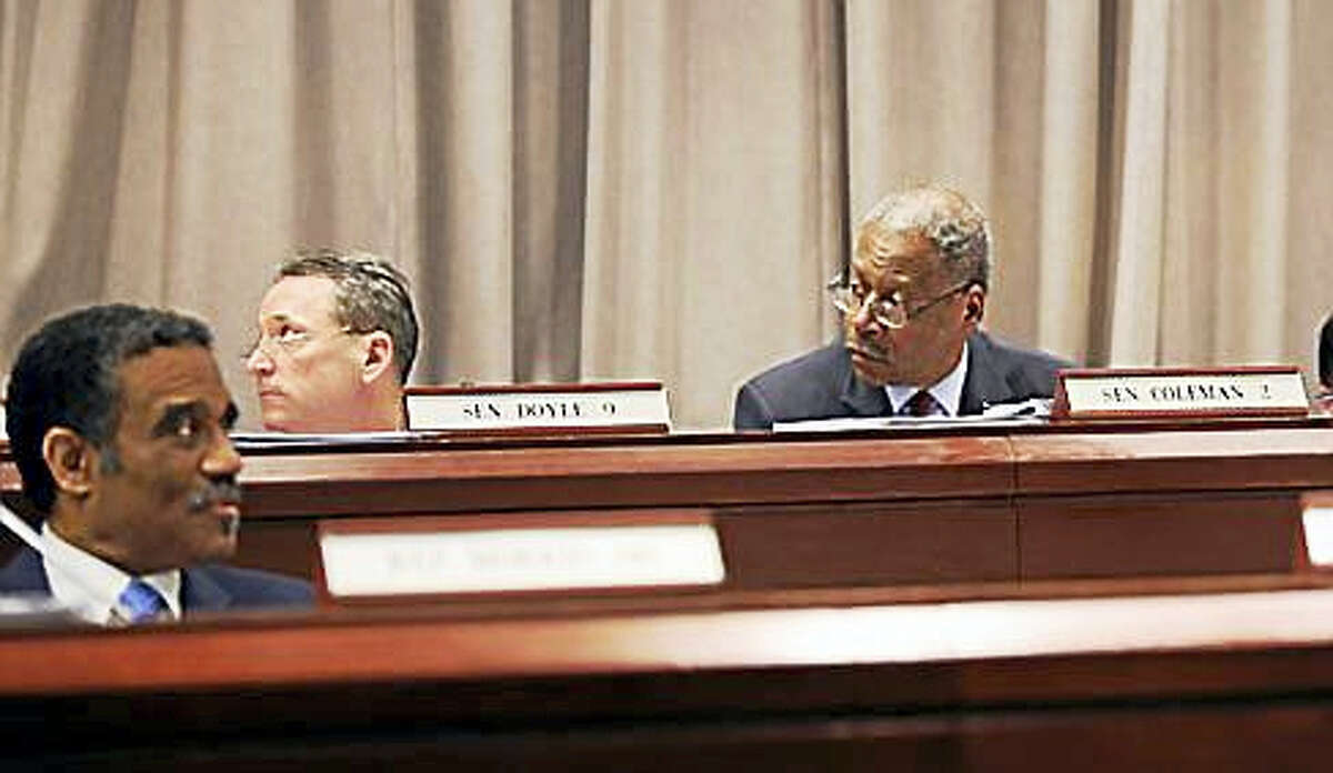 State Sens. Eric Coleman and Paul Doyle, and Rep. Bruce Morris listen to the debate in the Judiciary Committee.