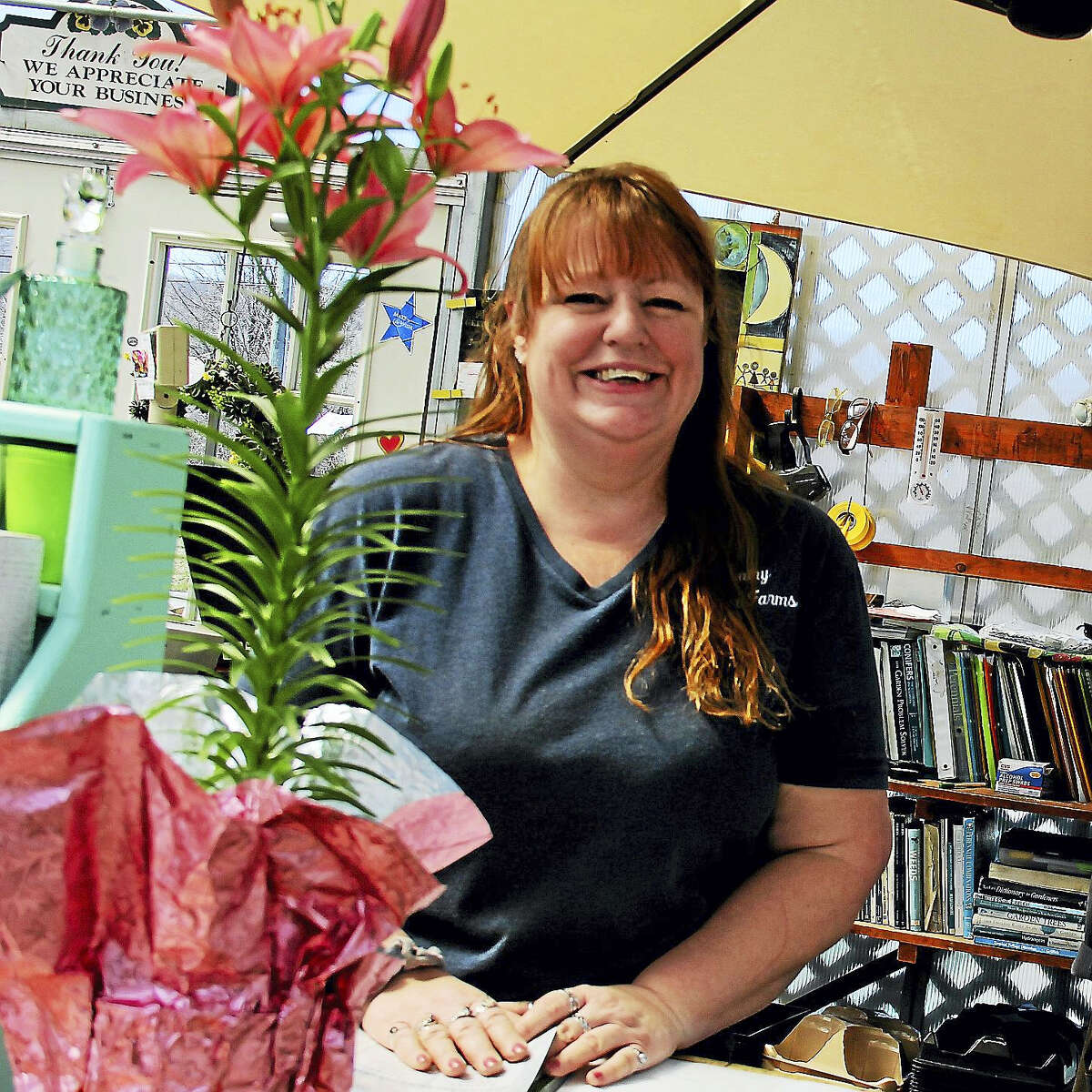 Customers meet a smiling Mary LeHerissier working behind the register at Country Flower Farm in Durham. The locally owned business organically grows all its stock, from flowers and plants to herbs and succulents.