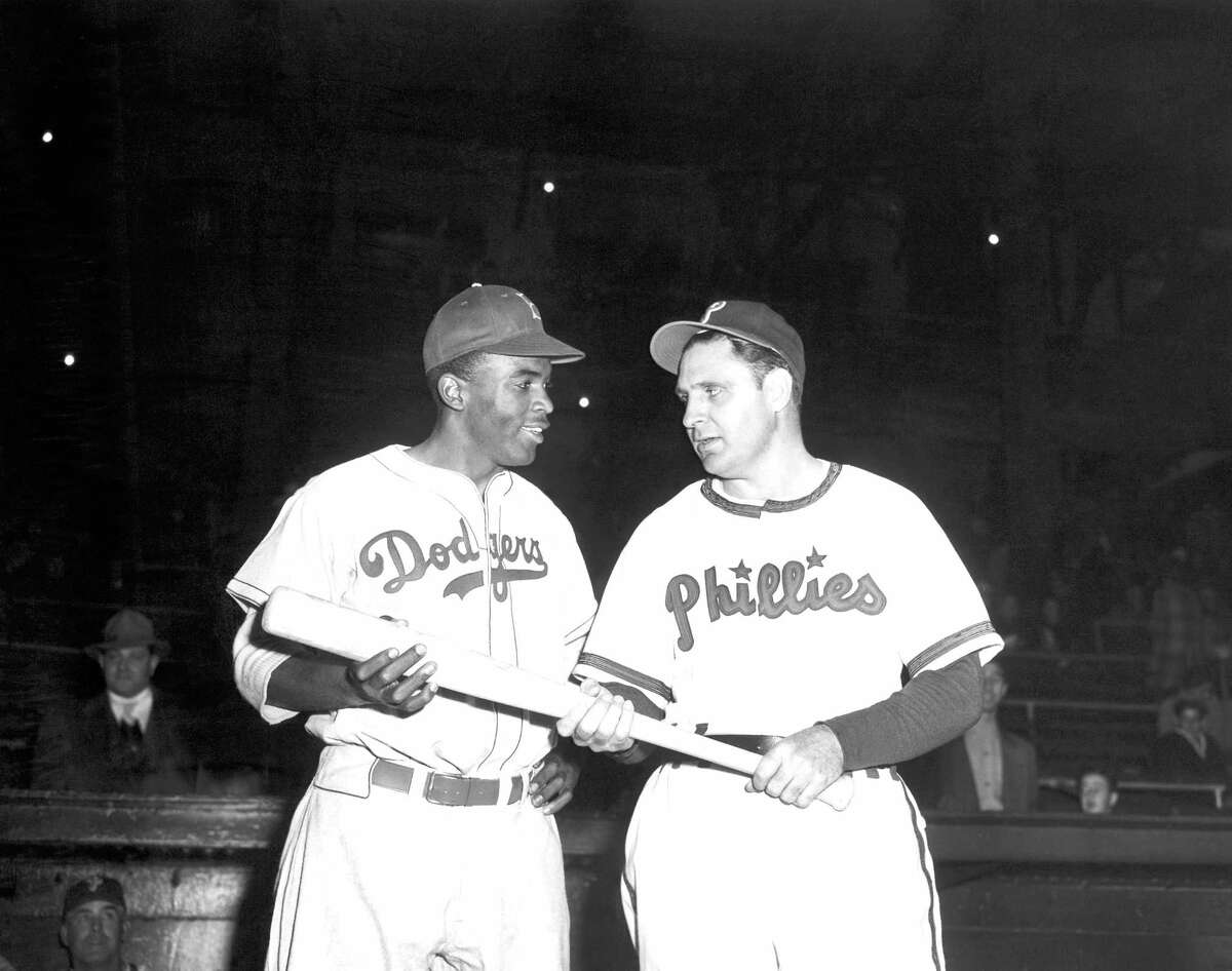In a May 9, 1947, file photo, Jackie Robinson, left, Brooklyn Dodgers’ first baseman, looks over the bat Philadelphia Phillies manager Ben Chapman uses during practice, as he prepared to play his first Philadelphia game for the Dodgers. The Philadelphia City Council unanimously passed a resolution Thursday, March 31, 2016, naming April 15, 2016, as a day to honor Robinson’s achievements and to apologize for the racism he faced while visiting Philadelphia in 1947. Robinson was refused service by a local hotel and then taunted by Philadelphia Phillies manager Ben Chapman, who, along with players, mercilessly hurled racial slurs at Robinson each time he came to bat.