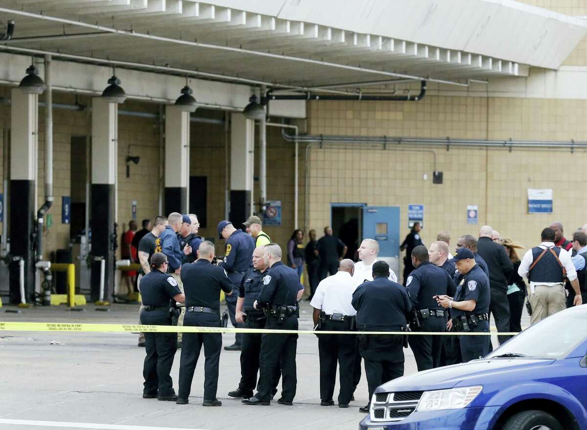 Police officers gather outside the Greyhound Bus Station in Richmond, Va. Thursday, March 31, 2016, after a shooting inside the terminal. Virginia State Police said at least two troopers responding to a shooting at a Richmond bus station and a civilian have been taken to a hospital. Spokeswoman Corinne Geller said the shooting suspect was in custody Thursday afternoon.