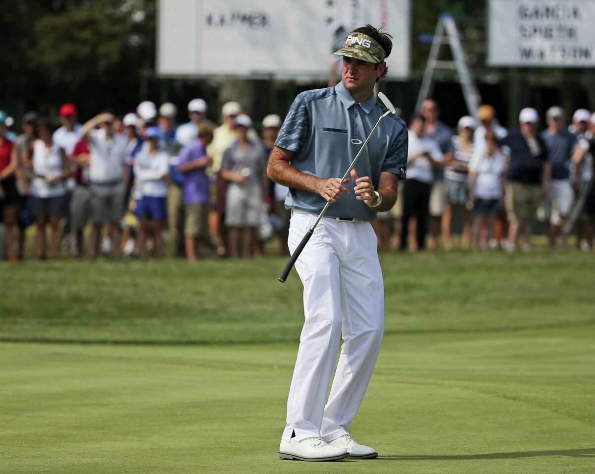 Bubba Watson reacts to missing a putt on the 11th hole during the first round of the PGA Championship golf at Baltusrol Golf Club in Springfield, N.J. Watson is committed to play again at the Travelers, where he is the defending champion.