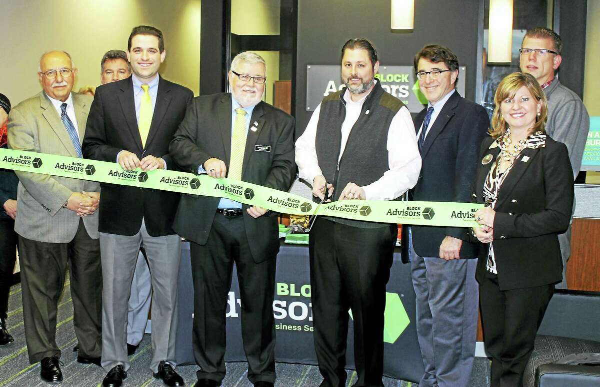 Block Advisors held its grand opening Jan. 14 at 51 Shunpike Road in Cromwell. From left are: Town Manager Anthony J. Salvatore, Vice President of the Middlesex County Chamber of Commerce Jeff Pugliese, Leon Zahaba Jr. of Block Advisors, Mayor Enzo Faienza, Director of Planning & Development Stuart B. Popper, Tracy Gardner of H&R Block, and co-chair of the Downtown Merchants Association Rodney Bitgood.