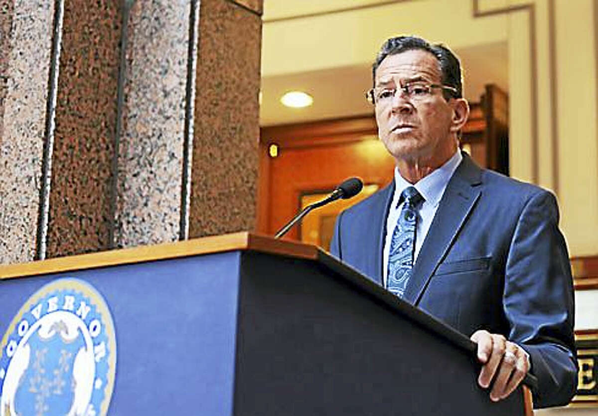 Gov. Dannel P. Malloy talks to the press following the Bond Commission meeting Friday.