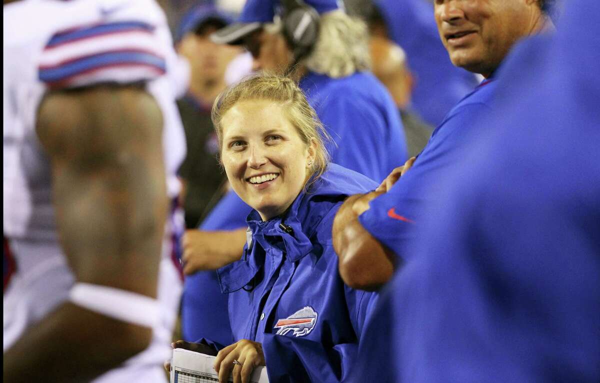 In this Aug. 13, 2016 photo, Buffalo Bills special teams and quality control coach Kathryn Smith works from the sideline during the second half of a preseason NFL football game against the Indianapolis Colts in Orchard Park, N.Y. In its report released Sept. 28,2 016, The Institute for Diversity and Ethics in Sport gave the NFL its seventh consecutive ‘A’ on racial hiring practices and a combined grade of B for hiring minorities and women.