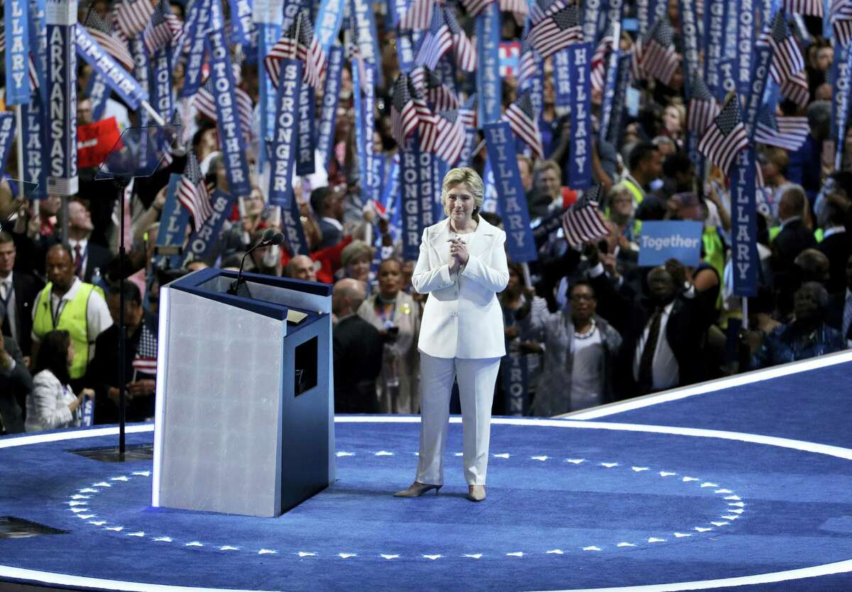 In this July 28 photo, Democratic presidential nominee Hillary Clinton reacts after speaking during the final day of the Democratic National Convention in Philadelphia. For eight summer nights, there were two starkly different visions of America at the Republican and Democratic political conventions.