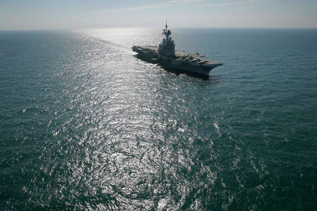 In this Tuesday, Jan. 12, 2016, file photo, France’s flagship Charles de Gaulle aircraft carrier navigates in the Persain Gulf as part of the U.S.- led coalition against the Islamic State grop, conducting airstrikes against extremist sites in Syria and Iraq in response to IS threats against French targets. Iran flew a surveillance drone over a U.S. aircraft carrier and took “precise” photographs of it as part of an ongoing naval drill, state television reported Friday. The U.S. Navy said an unarmed Iranian drone flew near a French and American carrier on Jan. 12, but couldn’t confirm it was the same incident.
