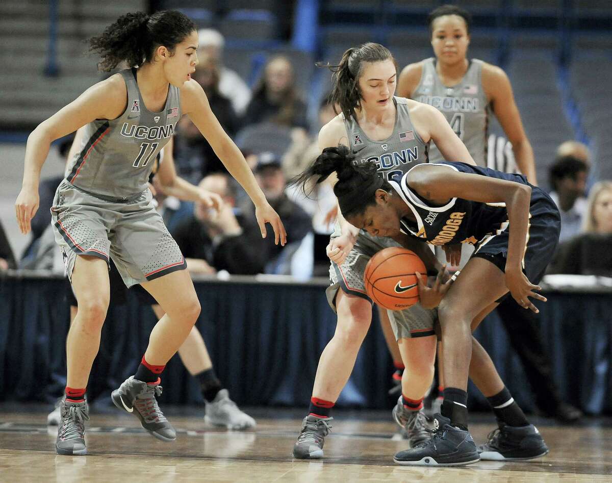 UConn’s Molly Bent, center, pressures Chattanooga’s Jasmine Joyner, right, as Connecticut’s Kia Nurse, left, defends in the first half Tuesday in Hartford.