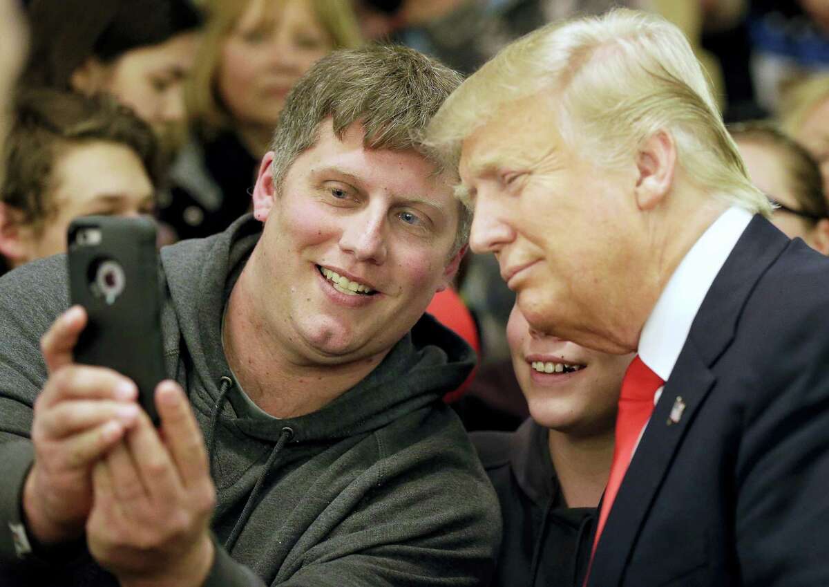 Mike Morrill takes a selfie with Republican presidential candidate Donald Trump during a rally Wednesday at the Radisson Paper Valley Hotel in Appleton, Wisconsin.