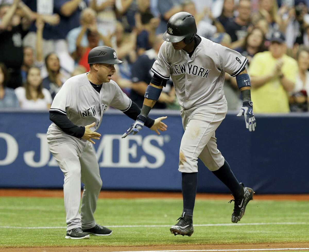 The Yankees’ Starlin Castro, right, celebrates with third base coach Joe Espada after hitting a two-run home run in the seventh inning on Sunday.