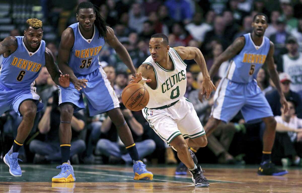 Boston Celtics guard Avery Bradley (0) looks to pass as he threads through the Denver Nuggets' defense during the second half of an NBA basketball game in Boston, Wednesday, Jan. 27, 2016. Boston won 111-103. (AP Photo/Charles Krupa)