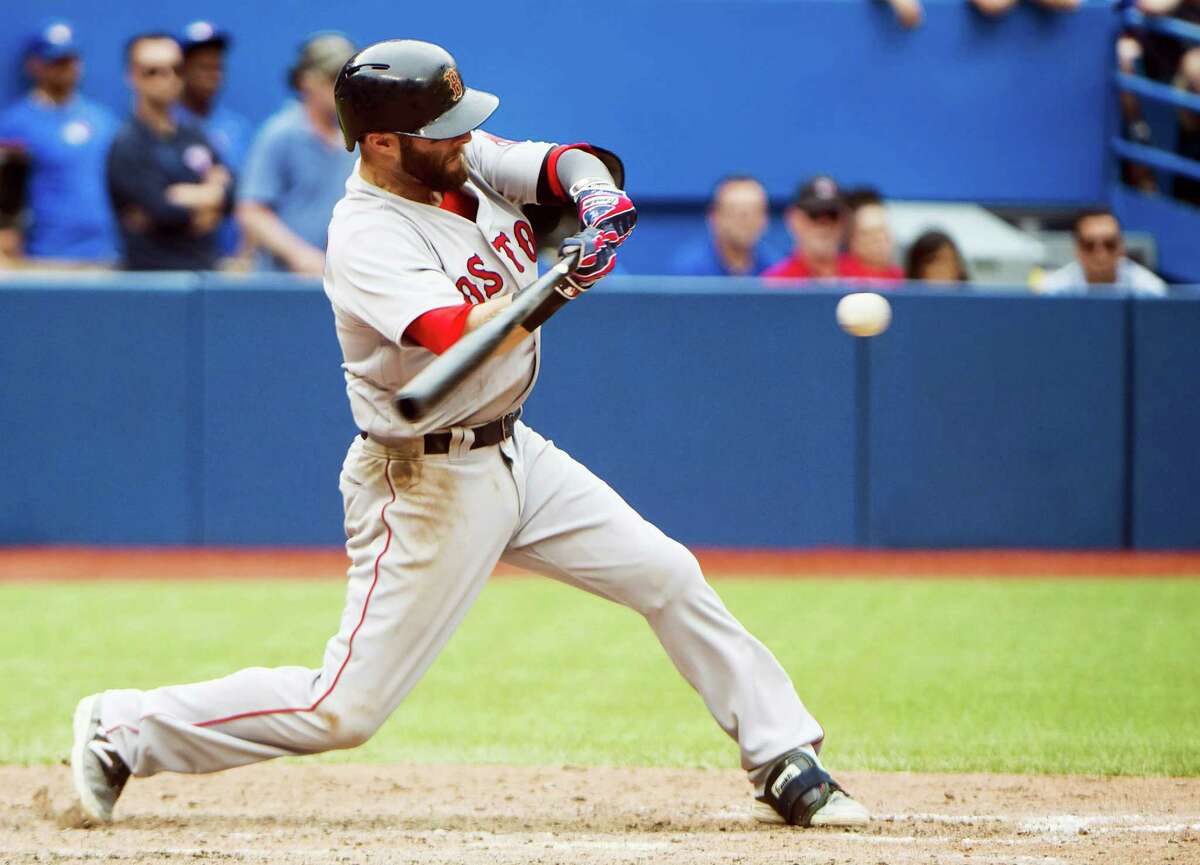 Dustin Pedroia hits an RBI double against the Jays during the 11th inning on Sunday.