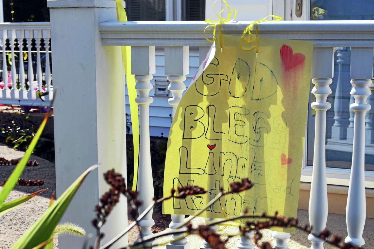 Yellow ribbons adorn Linda Carman’s Middletown home. Signs, bearing messages like “Never give up. Come home safe,” “Please pray for mom,” and “God bless Linda and Nathan,” are affixed to the house’s fences and bannisters.