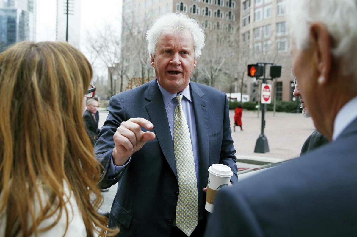 General Electric chairman and CEO Jeffrey Immelt, center, leaves the Boston Harbor Hotel after speaking at the Boston College Chief Executives Club on March 24, 2016.